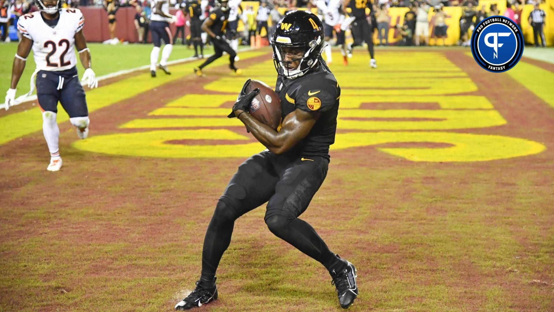Washington Commanders wide receiver Curtis Samuel (4) scores a touchdown against the Chicago Bears during the second half at FedExField.