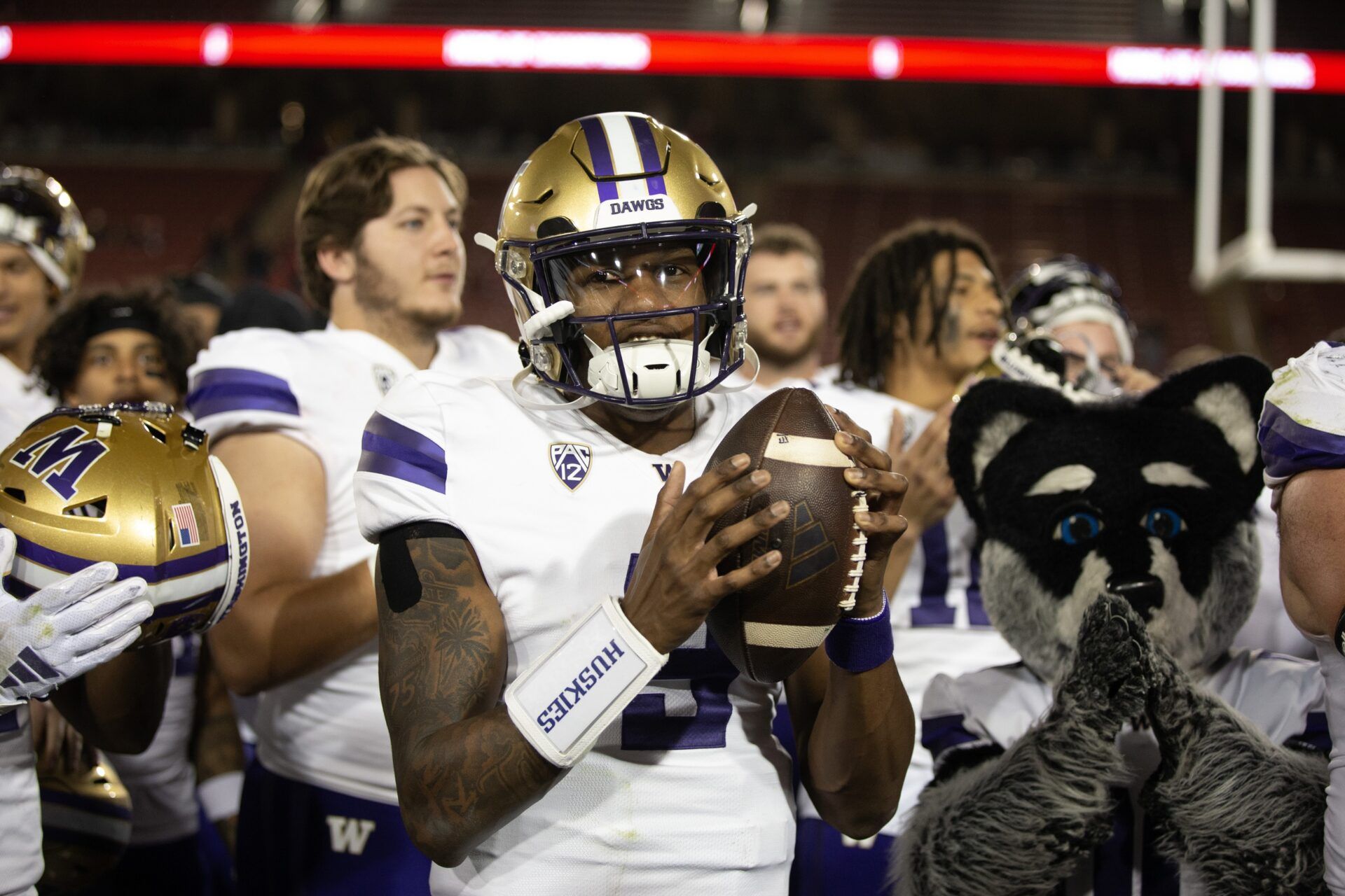 Washington Huskies QB Michael Penix Jr. (9) celebrates with teammates a win over Stanford.