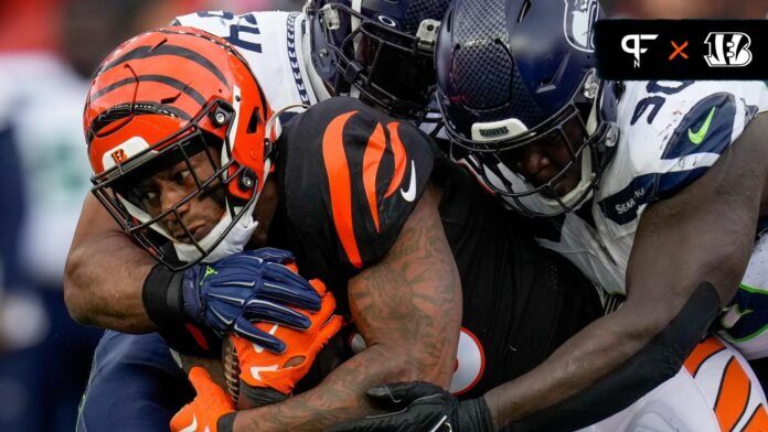 Cincinnati Bengals RB Joe Mixon (28) gets tackled by a group of Seattle Seahawks players.