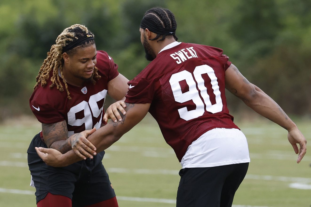 Washington Commanders pass rushers Chase Young (99) and Montez Sweat (90) practice during training camp.