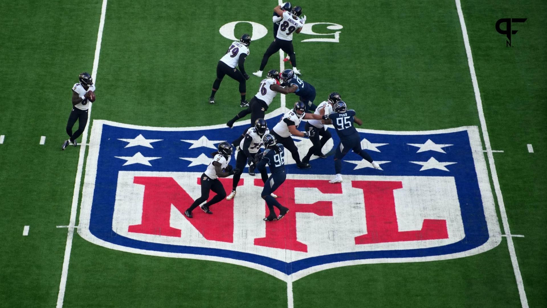 A general overall view as Baltimore Ravens quarterback Lamar Jackson (8) throws the ball at midfield on the NFL shield logo against the Tennessee Titans during an NFL International Series game at Tott...