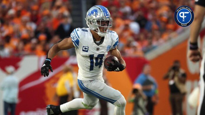 Amon-Ra St. Brown (14) runs with the ball against the Tampa Bay Buccaneers during the second half at Raymond James Stadium.