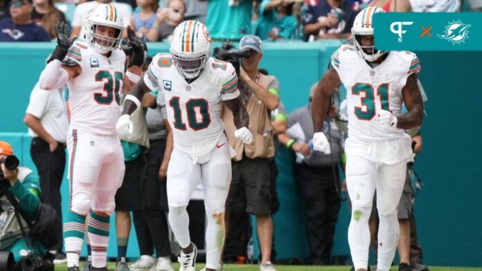 Miami Dolphins running back Raheem Mostert (31) celebrates his touchdown against the New England Patriots with wide receiver Tyreek Hill (10) by doing a speed walk celebration in the end zone during the second half at Hard Rock Stadium.