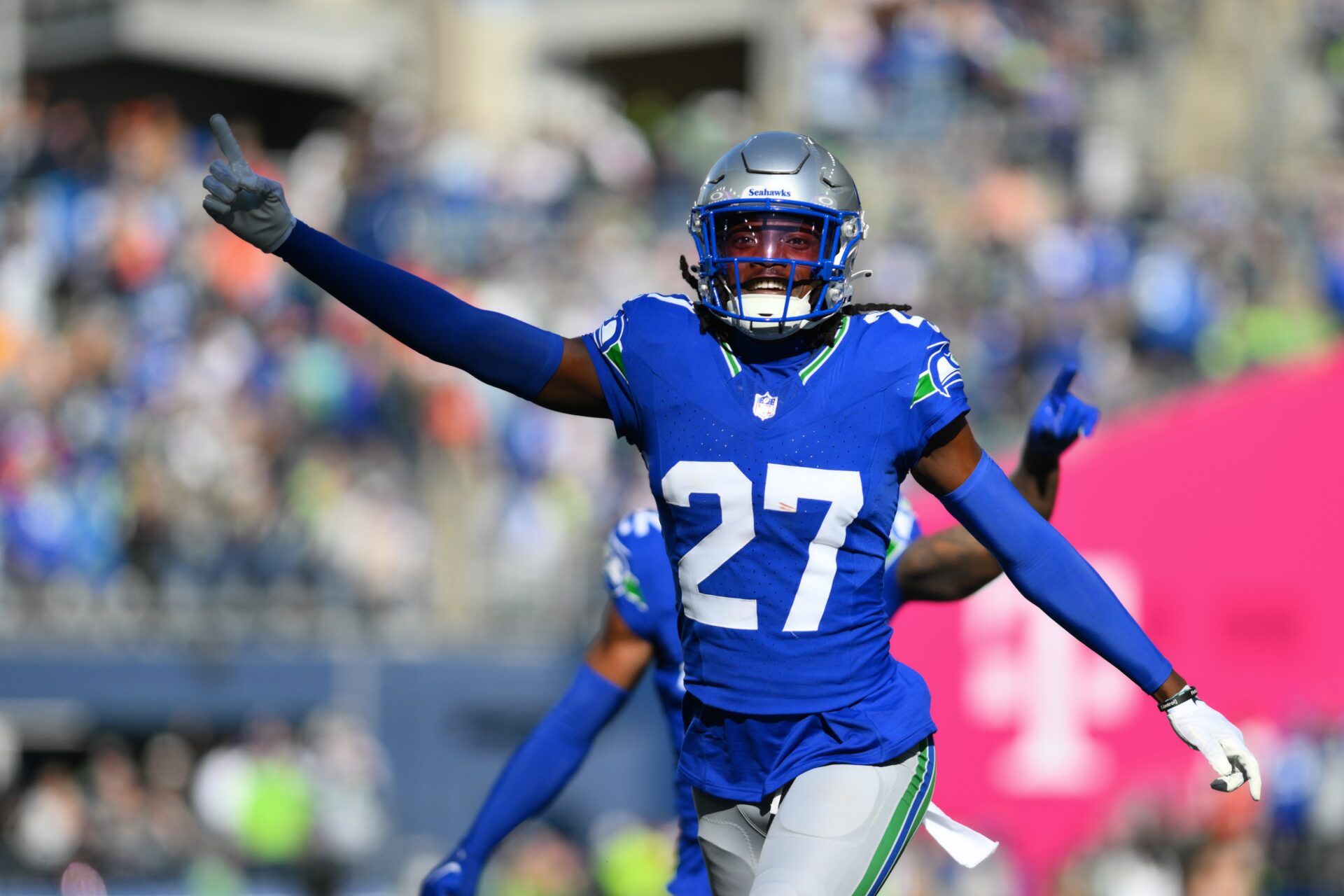 Riq Woolen (27) celebrates intercepting a pass against the Cleveland Browns during the first half at Lumen Field.