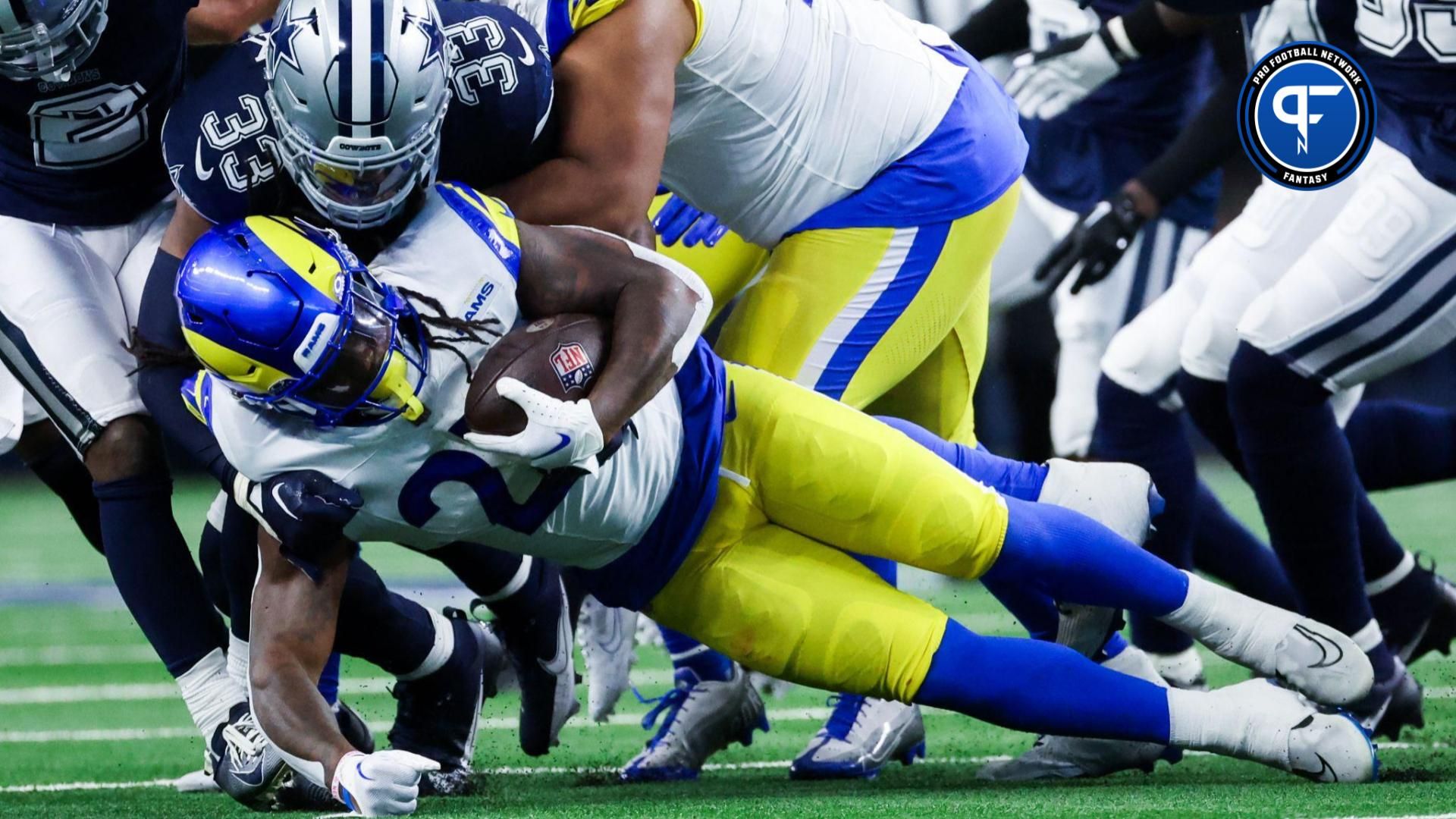 Dallas Cowboys linebacker Damone Clark (33) tackles Los Angeles Rams running back Darrell Henderson Jr. (27) during the first half at AT&T Stadium.
