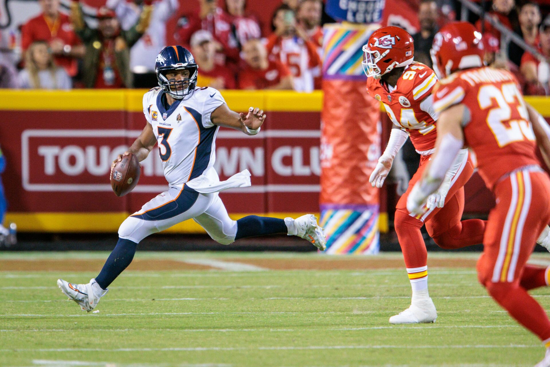 Denver Broncos quarterback Russell Wilson (3) scrambles in the backfield during the fourth quarter against the Kansas City Chiefs at GEHA Field at Arrowhead Stadium.