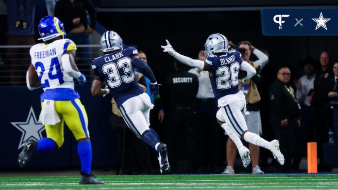 Dallas Cowboys cornerback DaRon Bland (26) scores a touchdown on an interception during the first quarter against the Los Angeles Rams at AT&T Stadium.