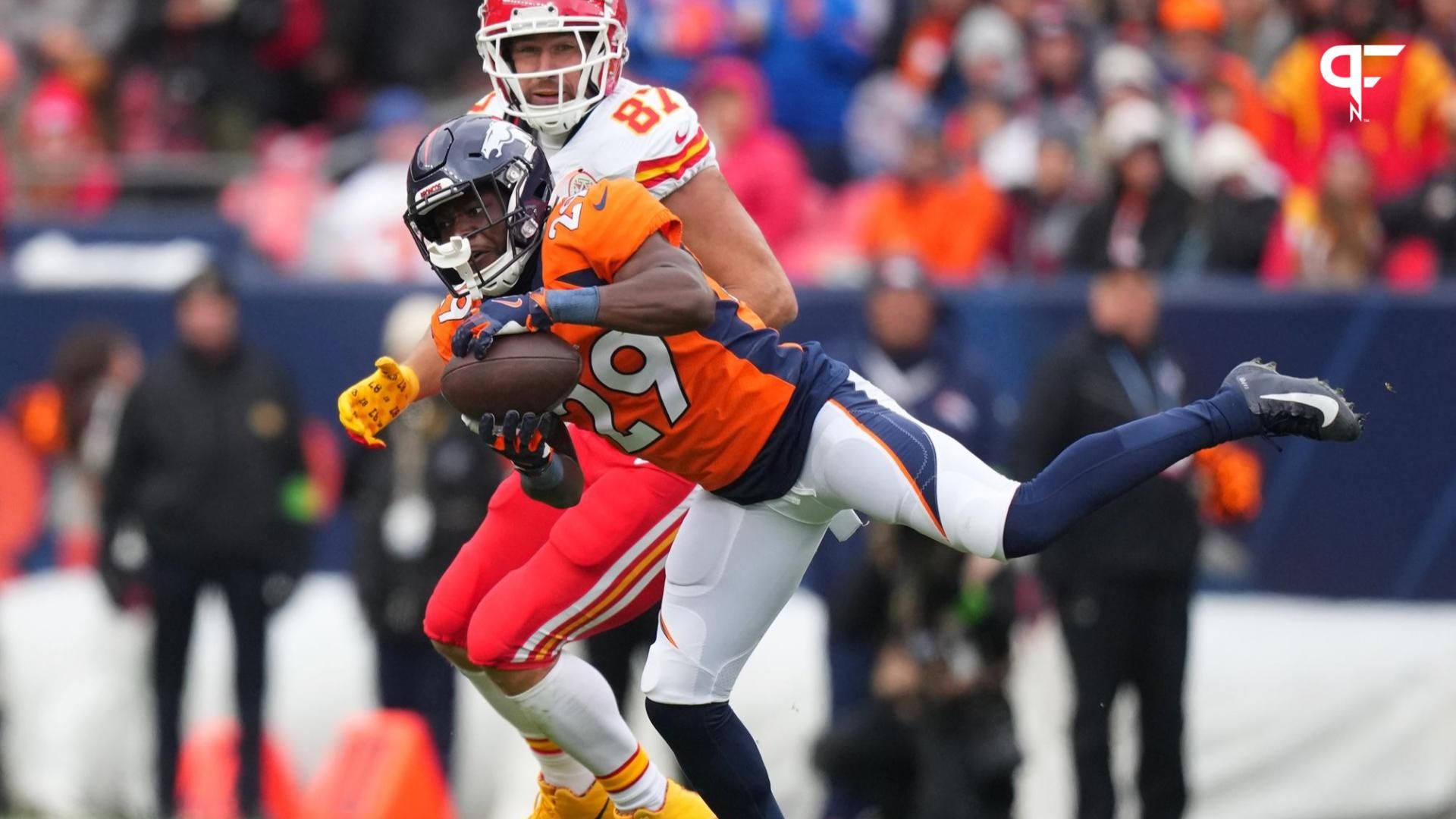 Denver Broncos cornerback Ja'Quan McMillian (29) intercepts a pass intended for Kansas City Chiefs tight end Travis Kelce (87) in the second quarter at Empower Field at Mile High.