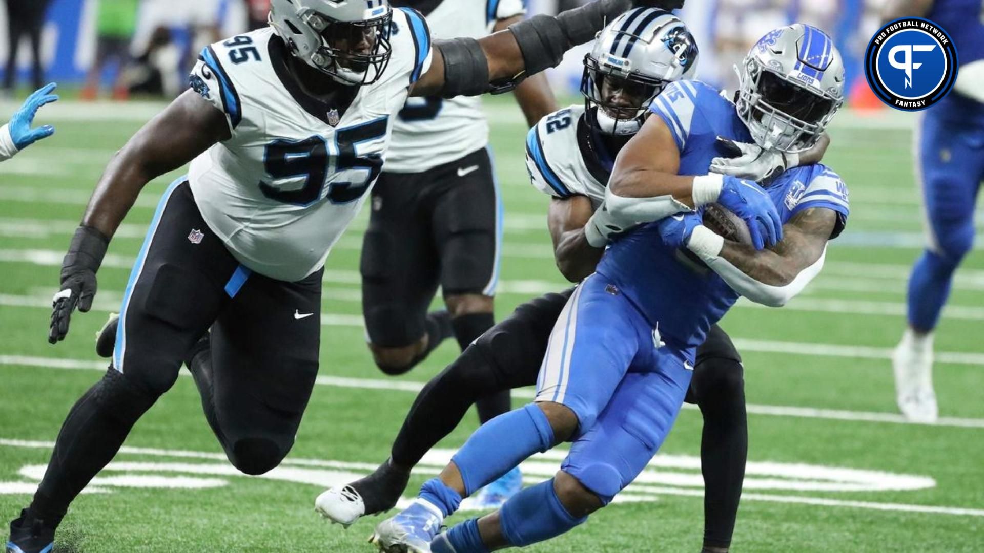 Detroit Lions running back David Montgomery (5) is tackled by Carolina Panthers safety Sam Franklin Jr. (42).