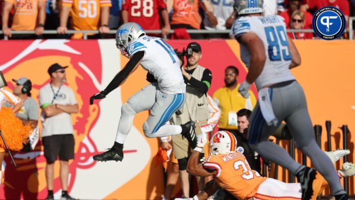 Detroit Lions wide receiver Amon-Ra St. Brown (14) runs the ball for a touchdown against the Tampa Bay Buccaneers.