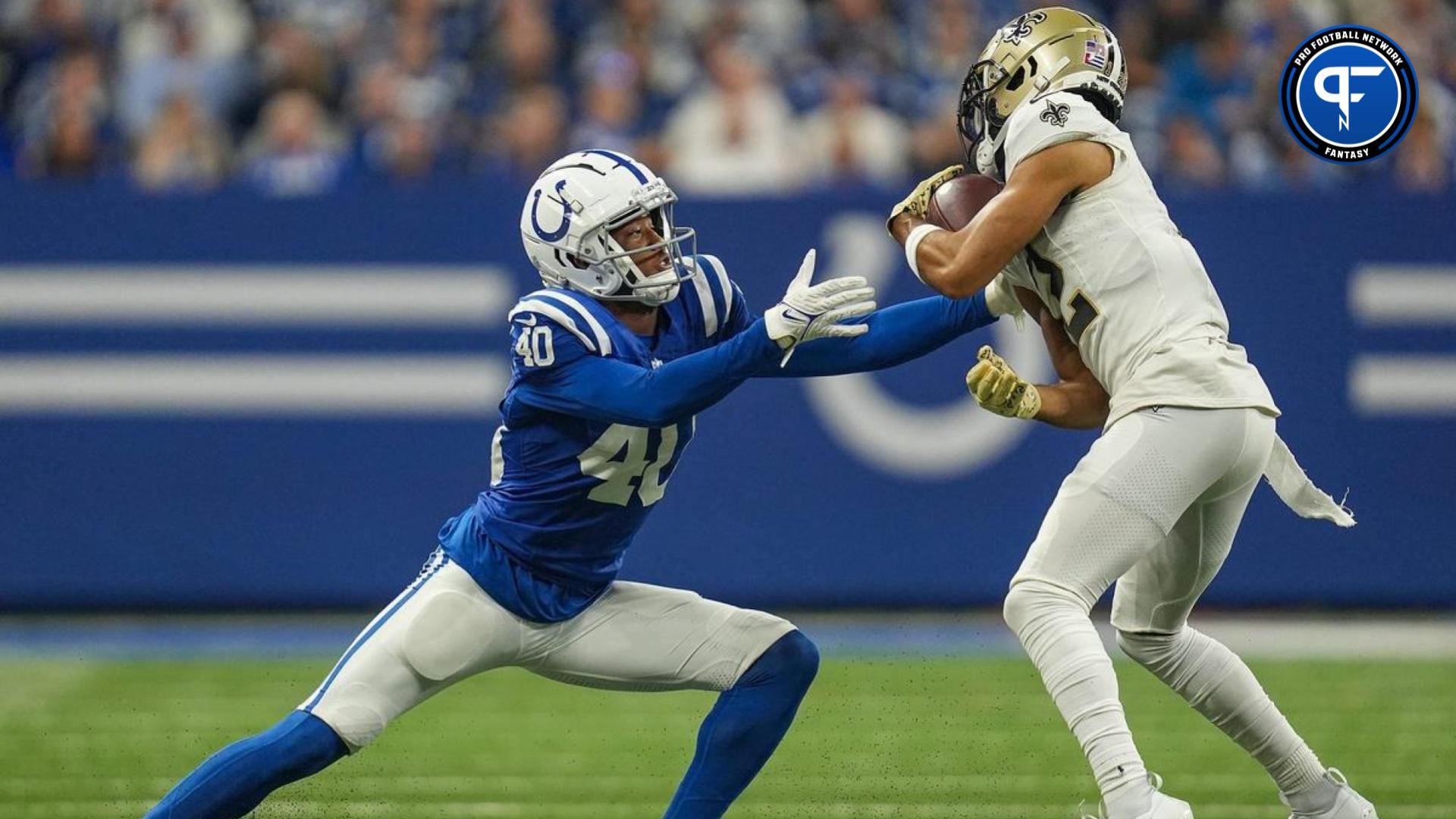 Indianapolis Colts cornerback Jaylon Jones (40) moves in on New Orleans Saints wide receiver Chris Olave (12) as he carries the ball.