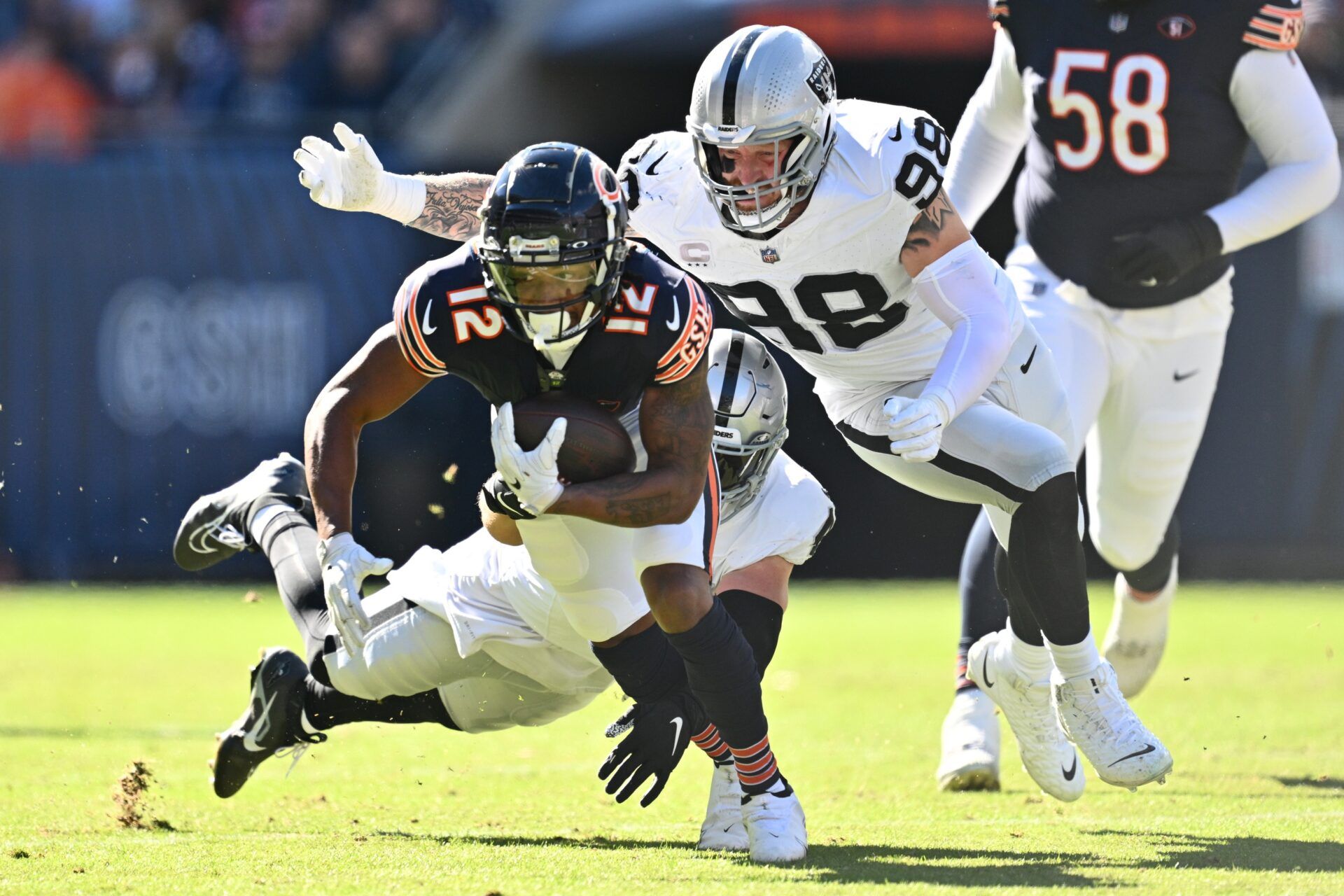 Chicago Bears wide receiver Velus Jones Jr. II (12) is brought down by Las Vegas Raiders defensive end Maxx Crosby (98).