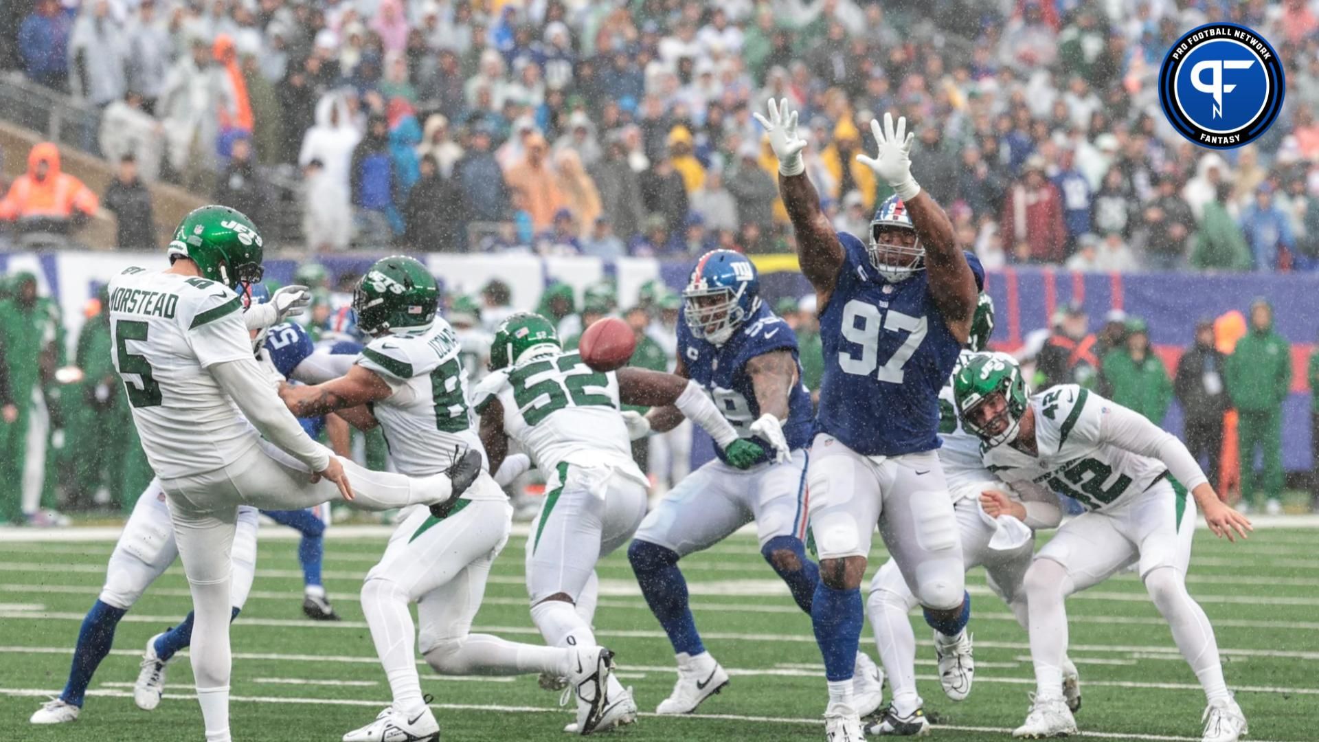New York Jets punter Thomas Morstead (5) punts the ball as New York Giants defensive tackle Dexter Lawrence II (97) defends.