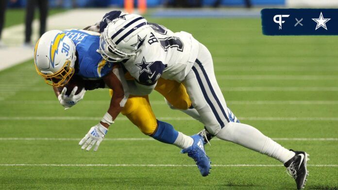 Dallas Cowboys safety Markquese Bell (14) tackles Los Angeles Chargers running back Austin Ekeler (30) during the third quarter at SoFi Stadium.