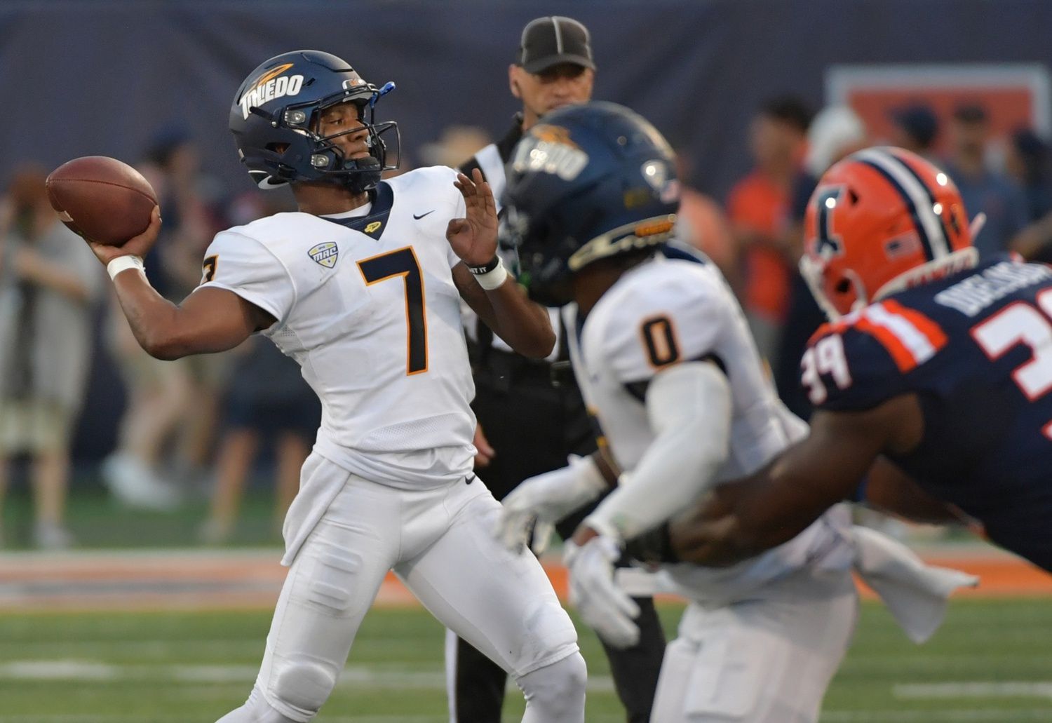 Toledo Rockets quarterback Dequan Finn (7) passes during the first half against the Illinois Fighting Illini at Memorial Stadium.