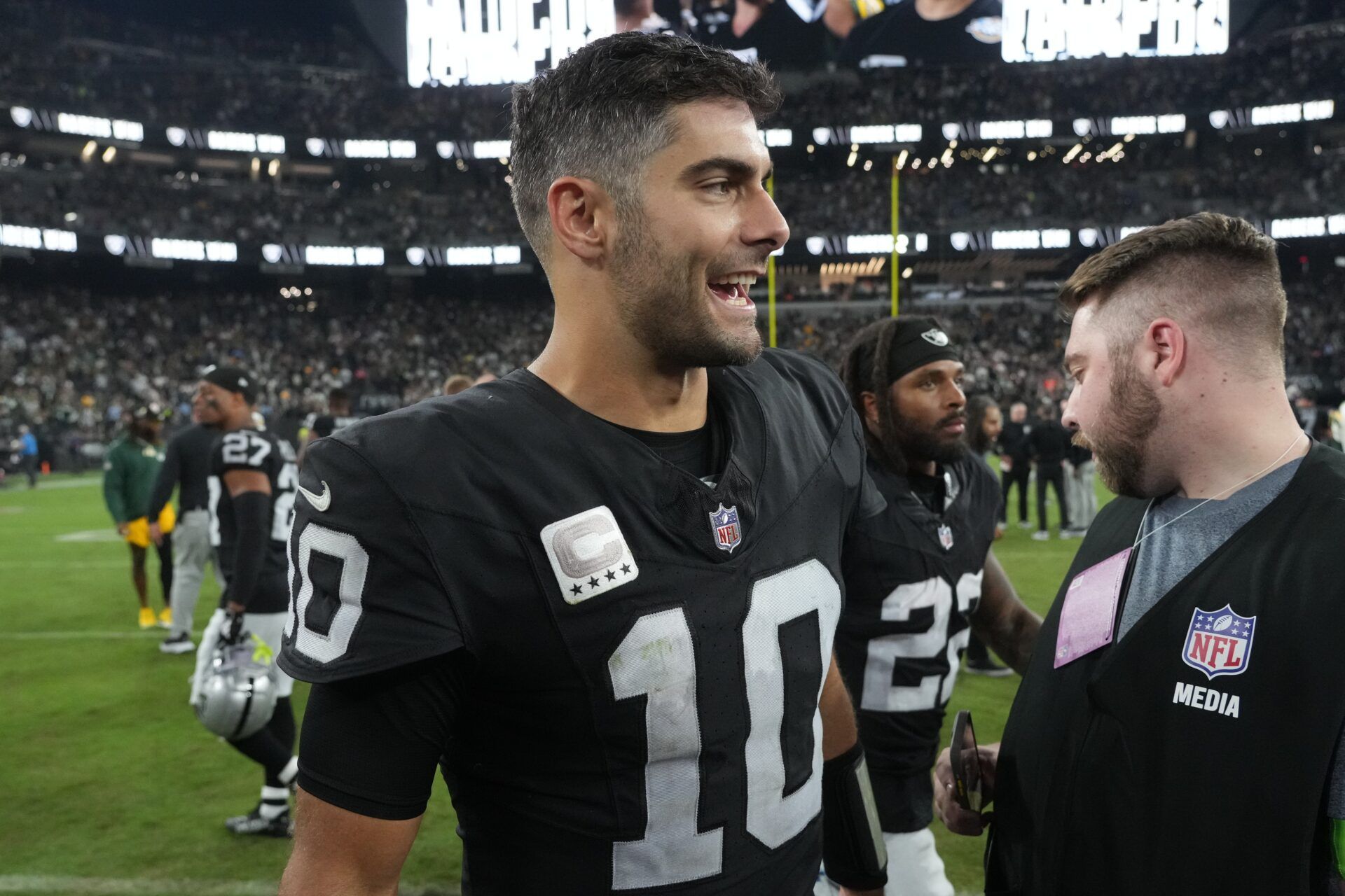 Las Vegas Raiders QB Jimmy Garoppolo (10) smiles on the field after a game.