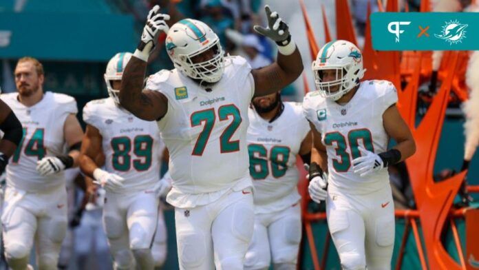 Terron Armstead (72) leads the team onto the field before a game against the Denver Broncos at Hard Rock Stadium.