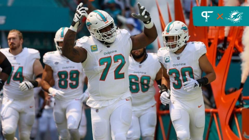 Terron Armstead (72) leads the team onto the field before a game against the Denver Broncos at Hard Rock Stadium.
