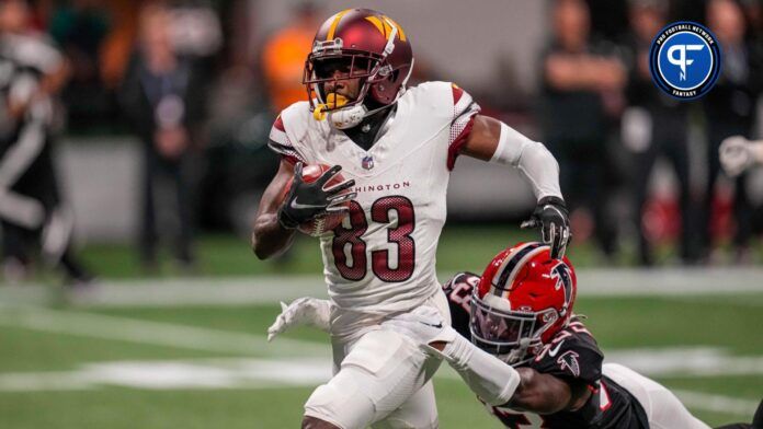 Washington Commanders wide receiver Jamison Crowder (83) is tackled by Atlanta Falcons cornerback Tre Flowers (33) after a long punt return during the first half at Mercedes-Benz Stadium.