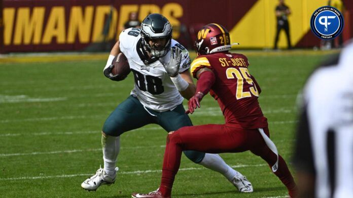 Dallas Goedert (88) carries the ball as Washington Commanders cornerback Benjamin St-Juste (25) defends during the first half at FedExField.