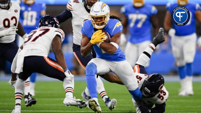 Los Angeles Chargers linebacker Blake Lynch (53) and safety Jaylinn Hawkins (37) attempt to tackle Los Angeles Chargers wide receiver Quentin Johnston (1) during the second quarter at SoFi Stadium.