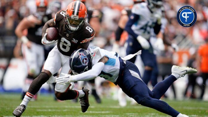 Cleveland Browns wide receiver Elijah Moore (8) is tackled by Tennessee Titans safety Amani Hooker (37).