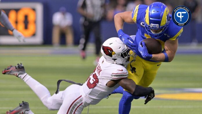 Los Angeles Rams wide receiver Cooper Kupp (10) pulls in a long pass as Arizona Cardinals cornerback Kei'Trel Clark (13) makes the tackle during the first half at SoFi Stadium.