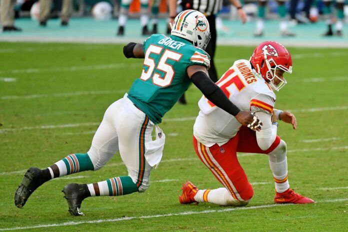 Miami Dolphins outside linebacker Jerome Baker (55) brings down Kansas City Chiefs quarterback Patrick Mahomes (15) during the second half at Hard Rock Stadium.