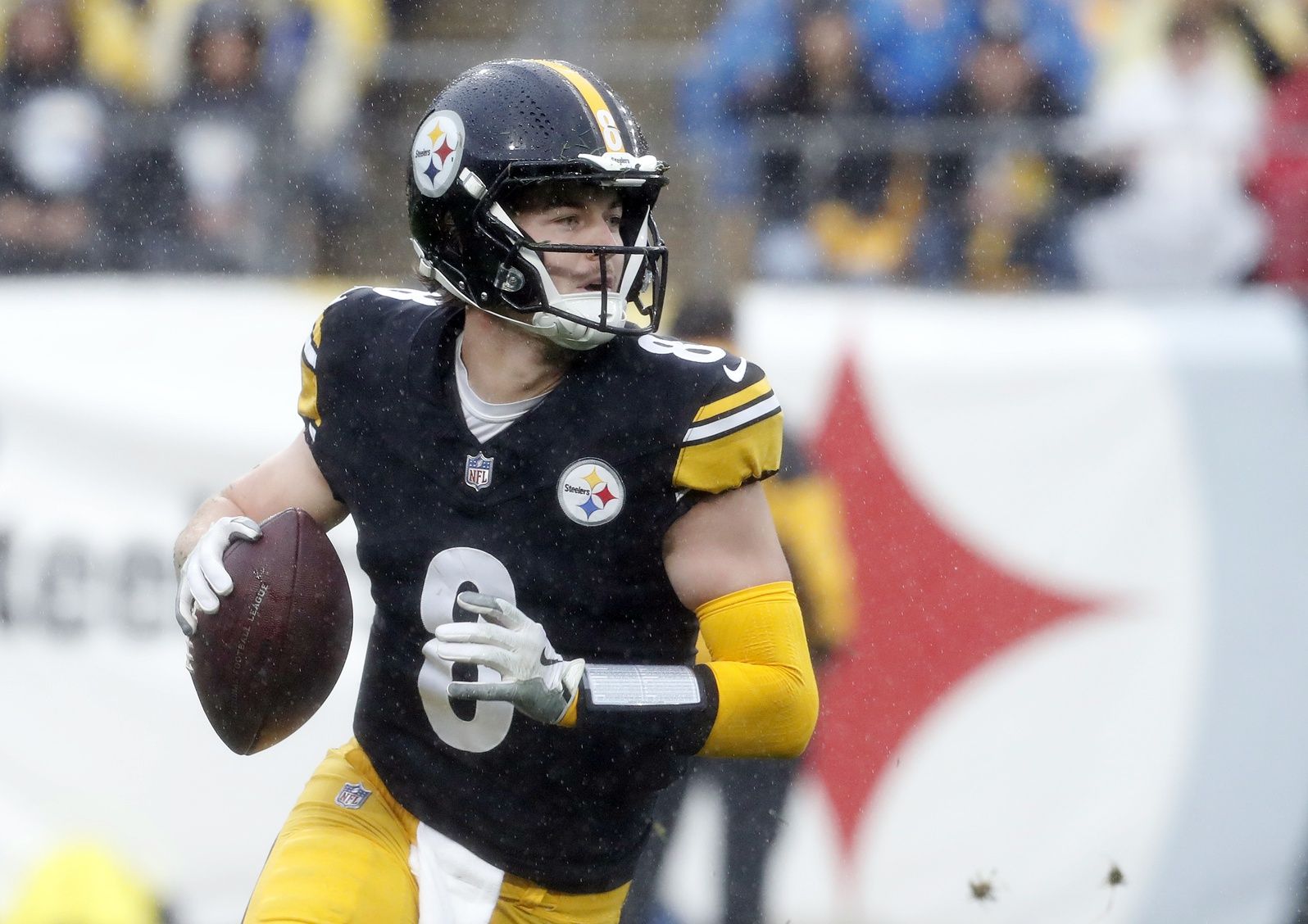 Pittsburgh Steelers quarterback Kenny Pickett (8) scrambles with the ball against the Jacksonville Jaguars during the first quarter at Acrisure Stadium.