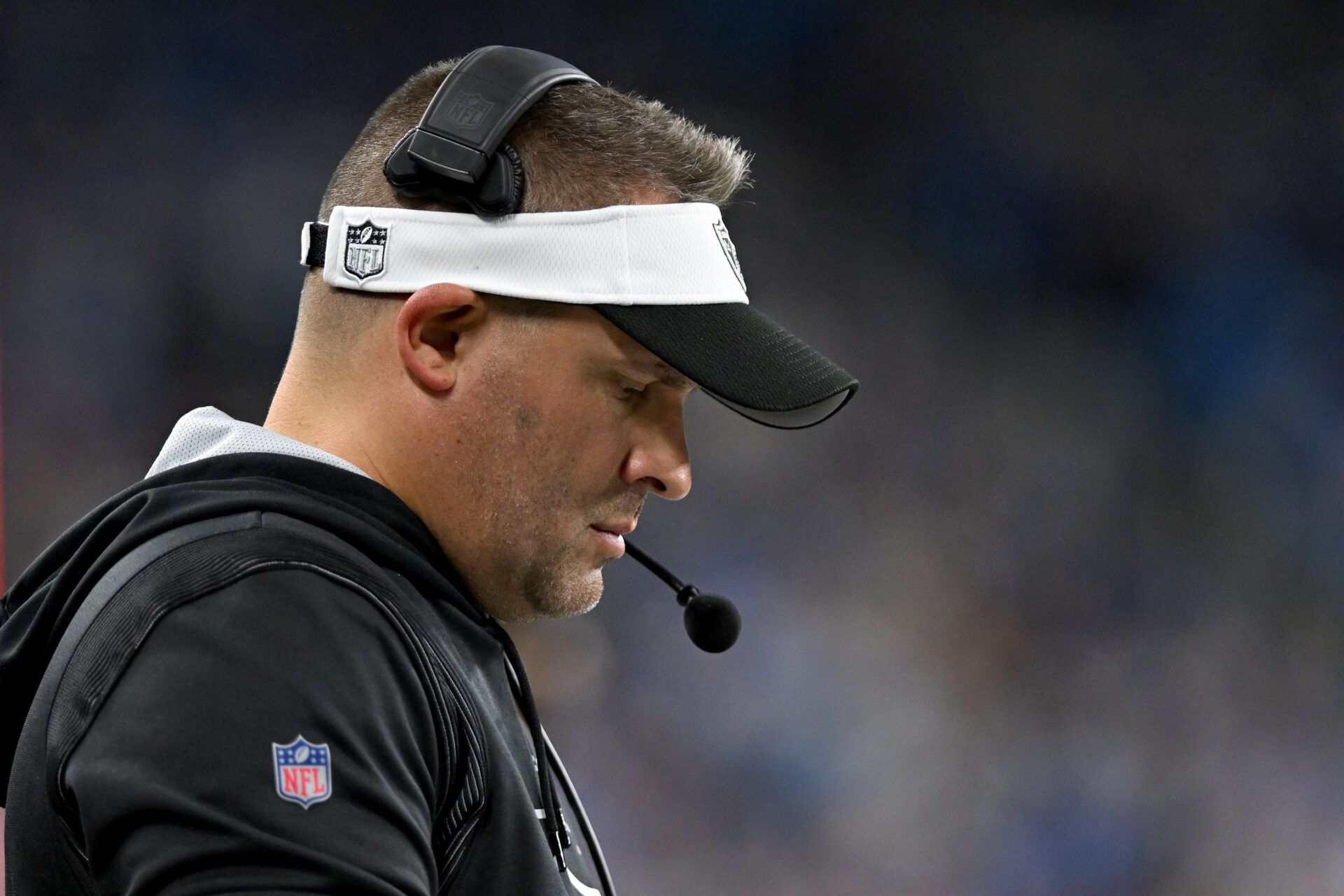 Oct 30, 2023; Detroit, Michigan, USA; Las Vegas Raiders head coach Josh McDaniels checks his play sheet on the sidelines during the fourth quarter of their game against the Detroit Lions at Ford Field. Mandatory Credit: Lon Horwedel-USA TODAY Sports