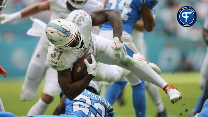 Miami Dolphins running back Raheem Mostert (31) goes over Carolina Panthers cornerback CJ Henderson (23).