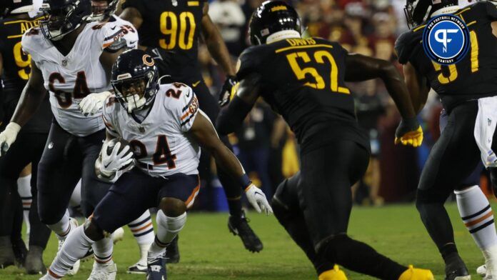 Chicago Bears running back Khalil Herbert (24) carries the ball as Washington Commanders linebacker Jamin Davis (52) chases.