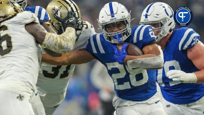 Indianapolis Colts RB Jonathan Taylor (28) tries to evade tackles against the New Orleans Saints.