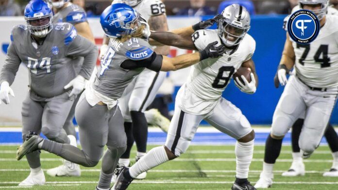 Las Vegas Raiders running back Josh Jacobs (8) runs with the ball as Detroit Lions linebacker Alex Anzalone (34) chases during the first half at Ford Field.