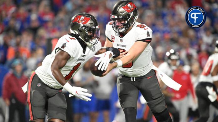 Tampa Bay Buccaneers quarterback Baker Mayfield (6) hands the ball to running back Rachaad White (1) in the first quarter against the Buffalo Bills at Highmark Stadium.