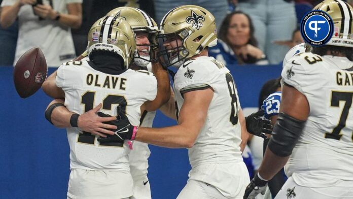 New Orleans Saints quarterback Taysom Hill (7), wide receiver Chris Olave (12) and tight end Foster Moreau (87) celebrate a touchdown.