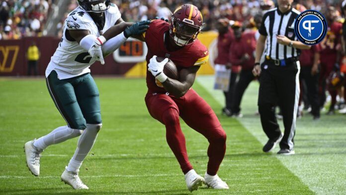 Brian Robinson Jr. (8) is pushed out of bounds by Philadelphia Eagles cornerback James Bradberry (24) during the first half at FedExField.