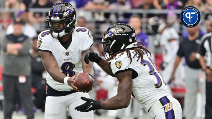 Baltimore Ravens quarterback Lamar Jackson (8) hands off to running back Gus Edwards (35) in the first half against the Arizona Cardinals.