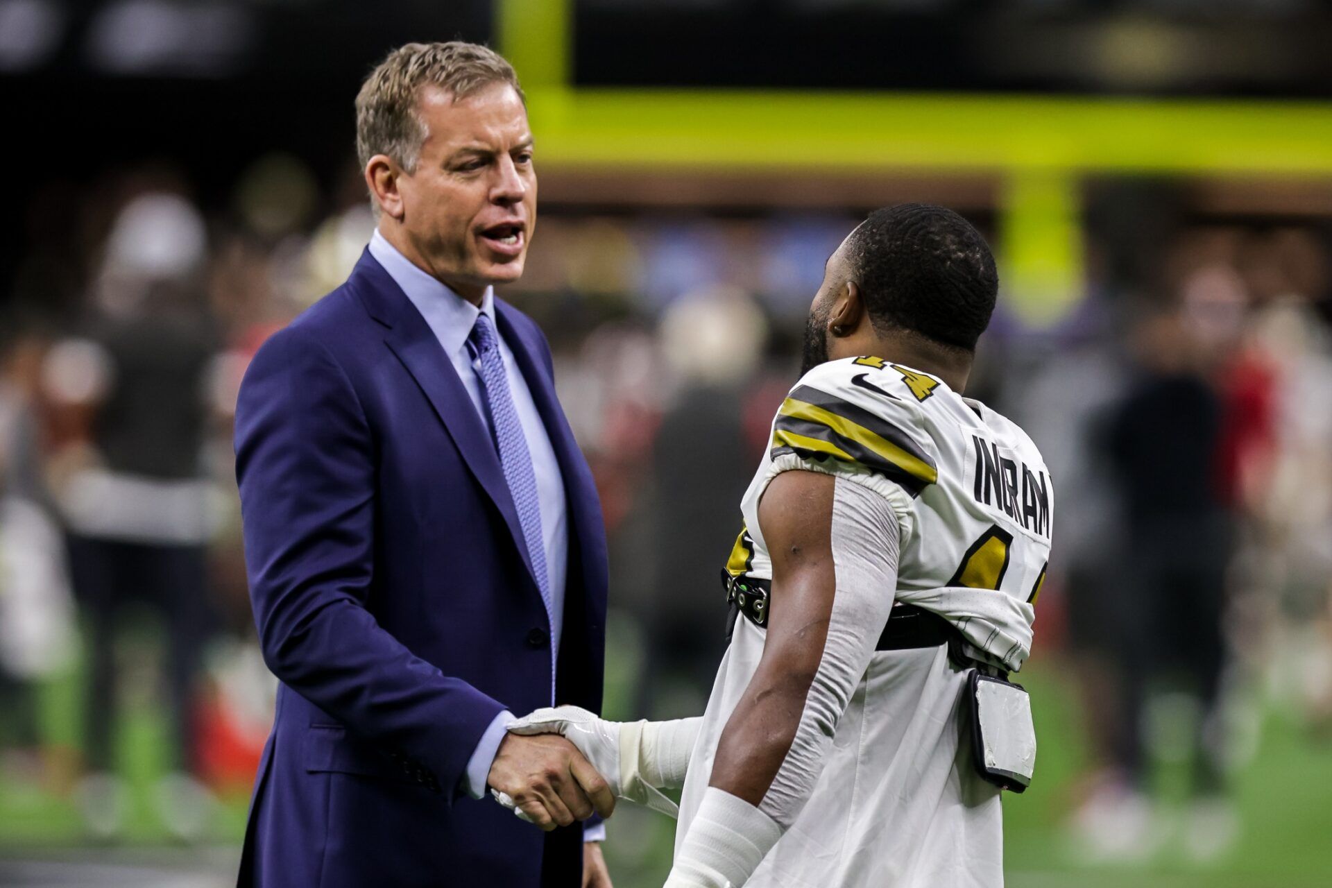 New Orleans Saints running back Mark Ingram II (14) shakes hands with NFL analyst Troy Aikman during pre-game warmups.