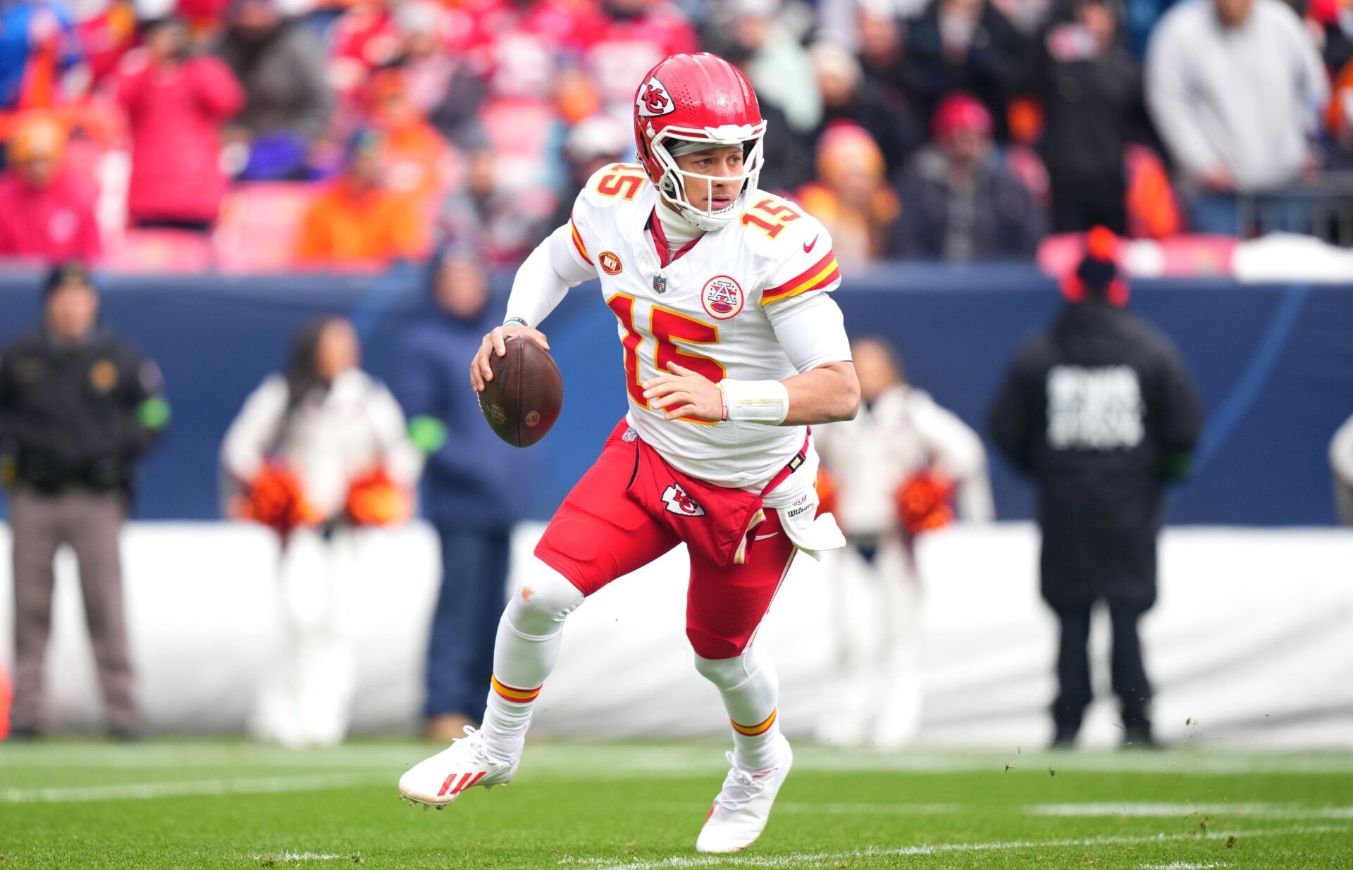 Kansas City Chiefs QB Patrick Mahomes (15) rolls out versus the Denver Broncos.