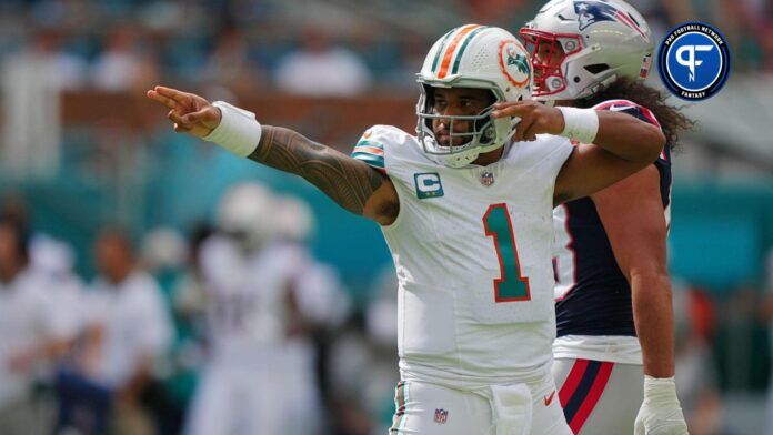 Miami Dolphins quarterback Tua Tagovailoa (1) celebrates after running the ball for a first down against the New England Patriots during the first half at Hard Rock Stadium.