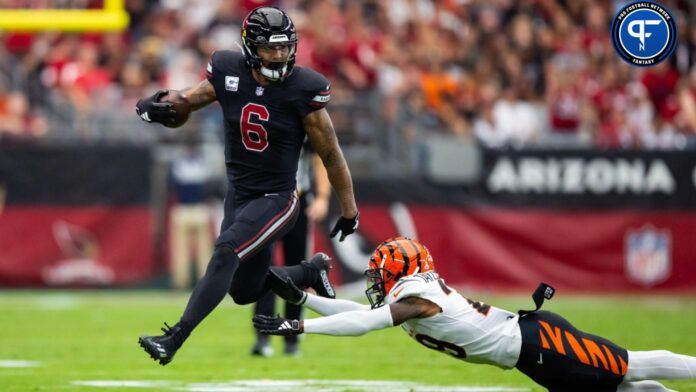 Arizona Cardinals running back James Conner (6) against diving Cincinnati Bengals cornerback Cam Taylor-Britt at State Farm Stadium.