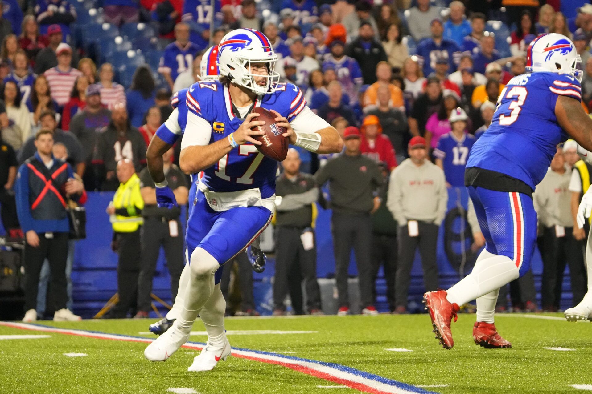 Buffalo Bills quarterback Josh Allen (17) rolls out looking to throw the ball against the Tampa Bay Buccaneers during the second half at Highmark Stadium.