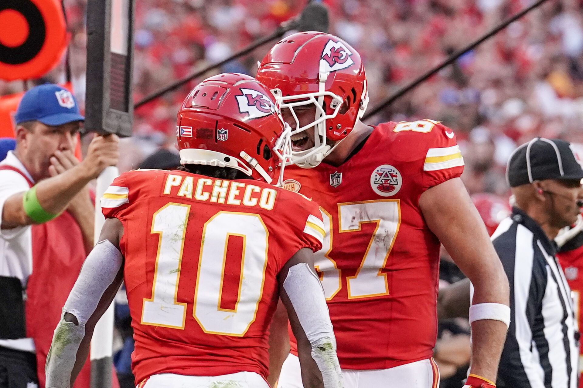 Kansas City Chiefs running back Isiah Pacheco (10) celebrates with tight end Travis Kelce (87) after scoring a touchdown against the Los Angeles Chargers during the second half at GEHA Field at Arrowhead Stadium.