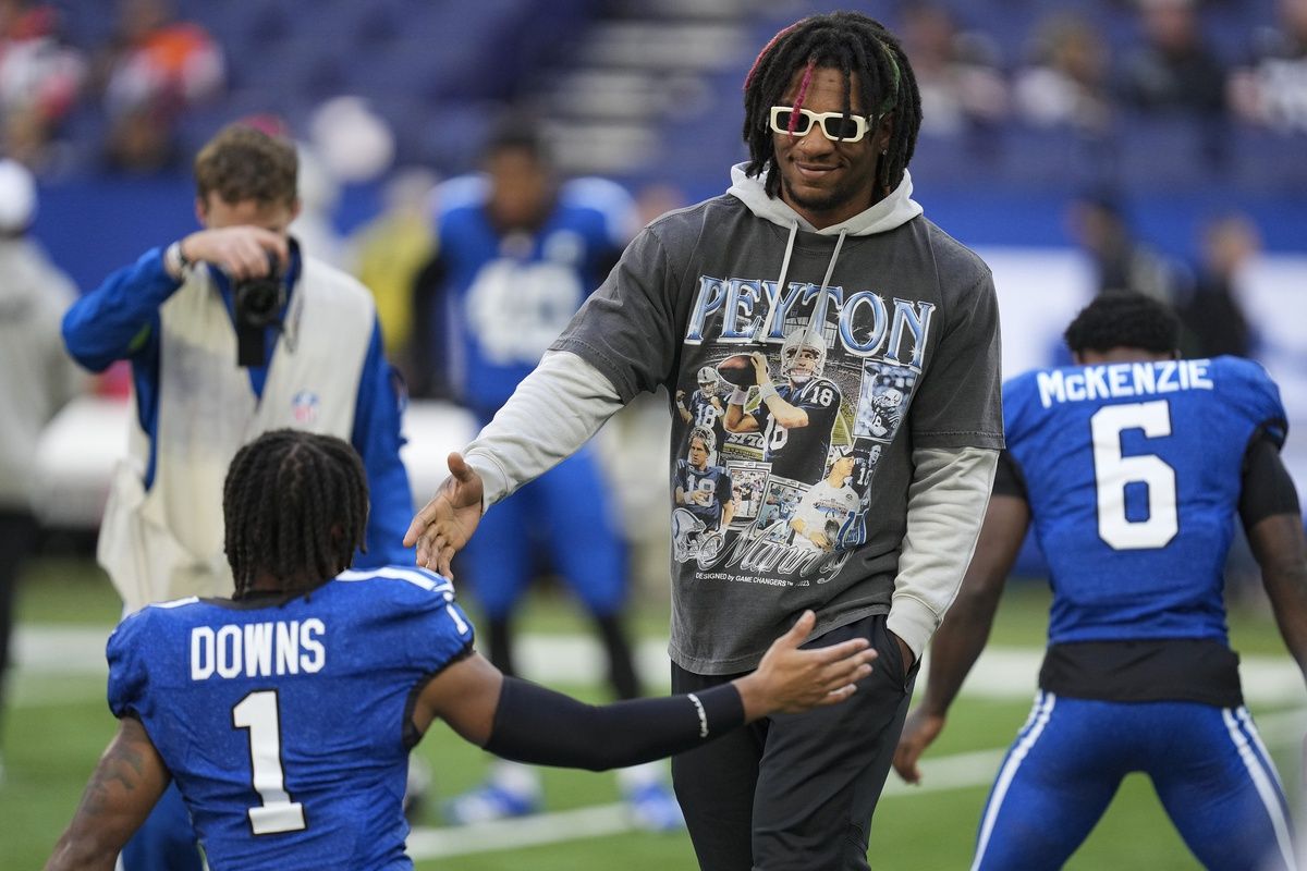 Anthony Richardson (5), who is out for the season due to injury, walks the field before the team faces the Cleveland Browns at Lucas Oil Stadium.