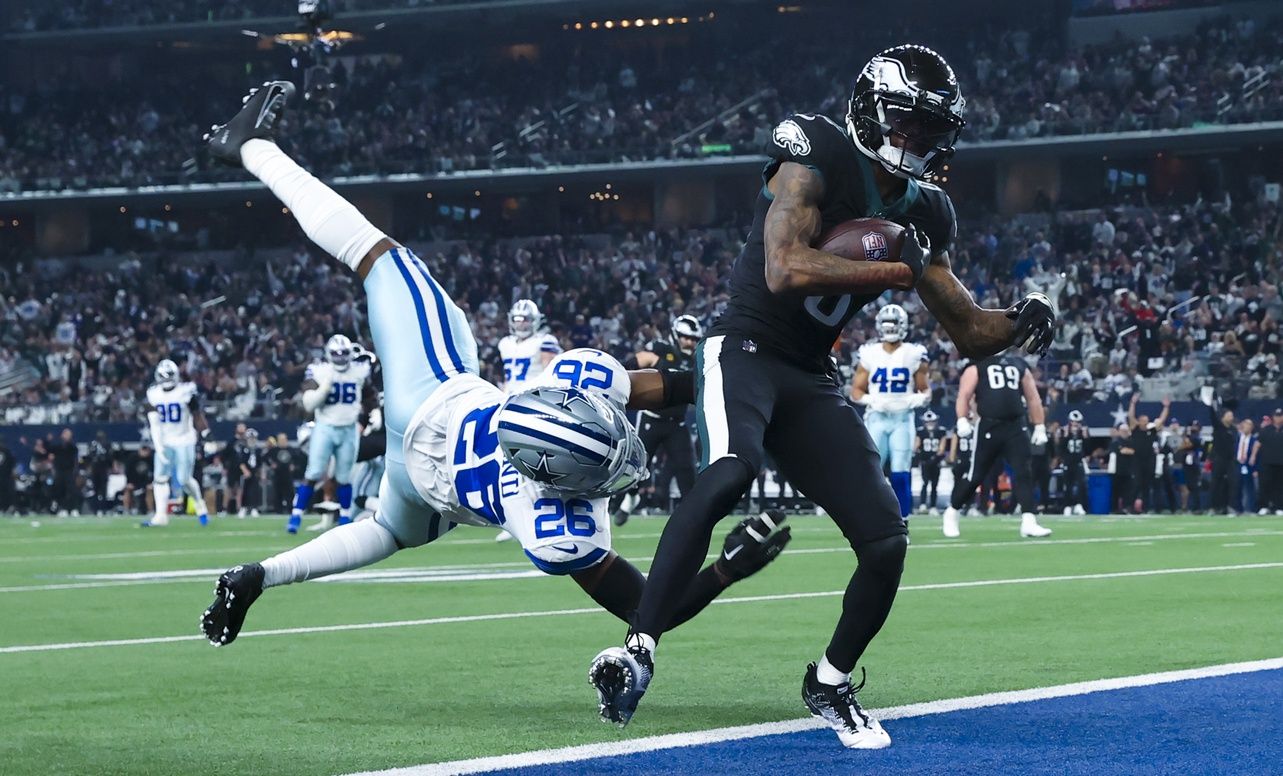 Philadelphia Eagles wide receiver DeVonta Smith (6) scores a touchdown past Dallas Cowboys cornerback DaRon Bland (26) during the second half at AT&T Stadium.