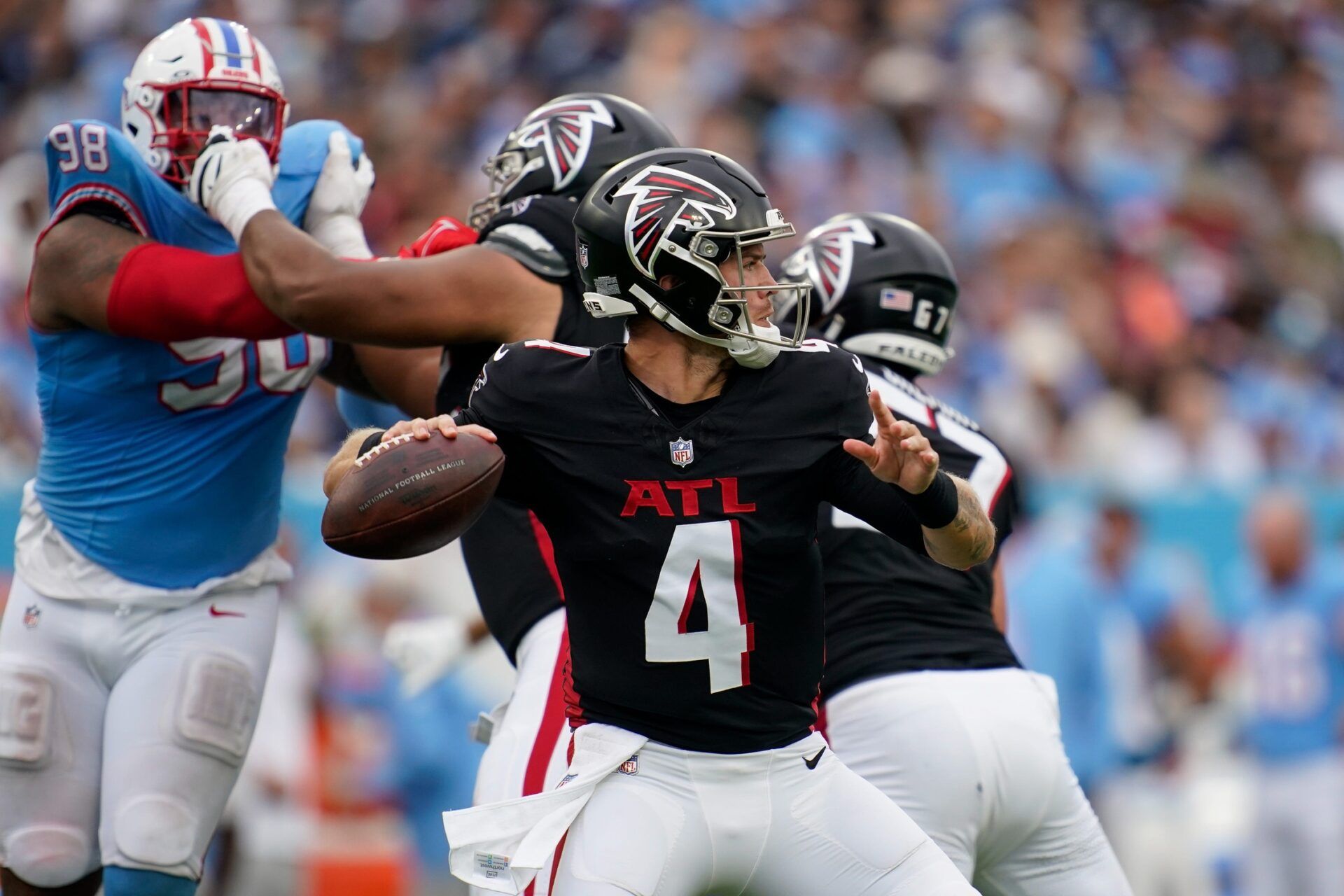 Atlanta Falcons quarterback Taylor Heinicke (4) looks for a receiver against the Tennessee Titans during the third quarter at Nissan Stadium in Nashville, Tenn., Sunday, Oct. 29, 2023.