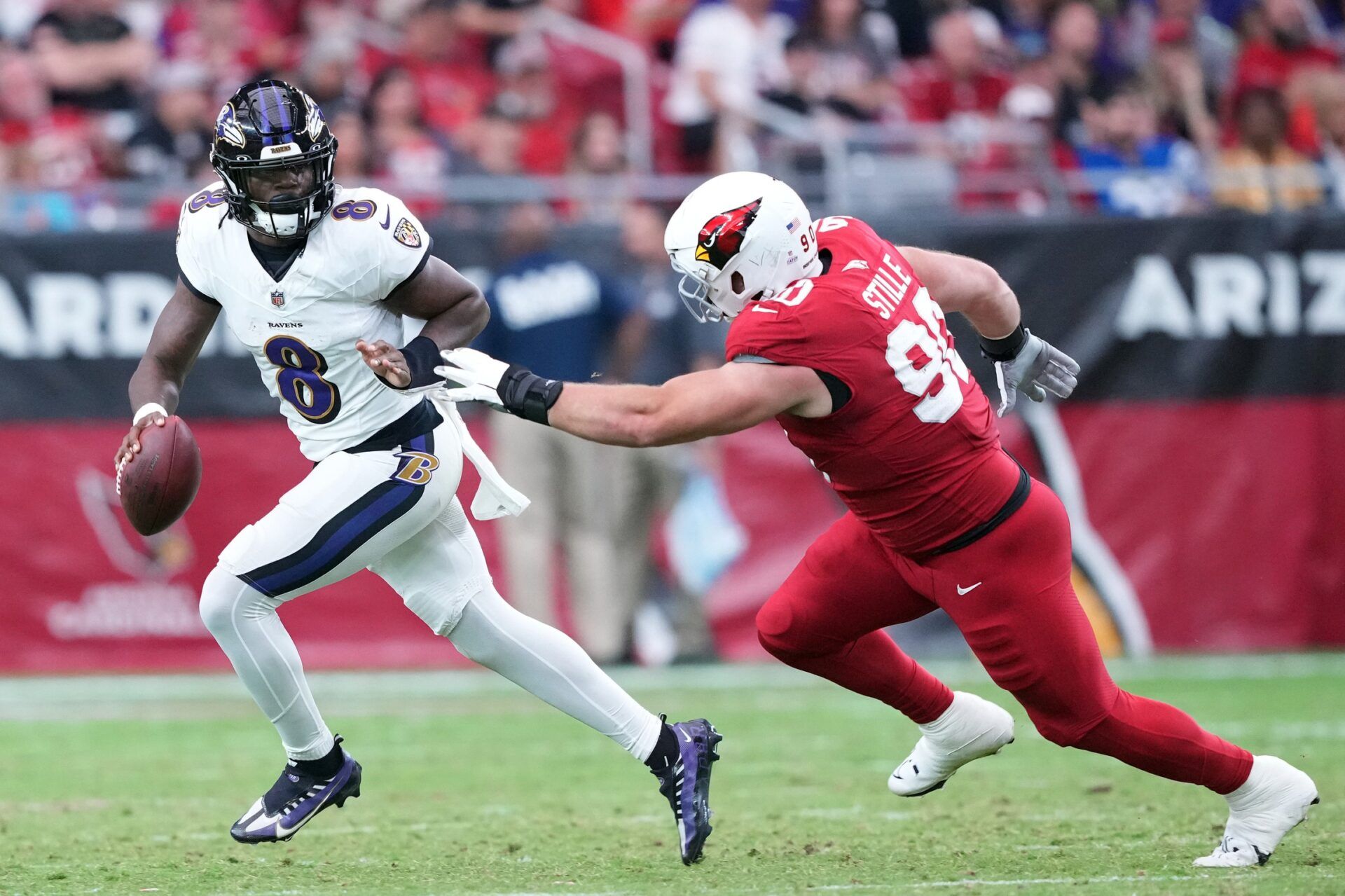 Baltimore Ravens QB Lamar Jackson (8) rolls out versus the Arizona Cardinals.