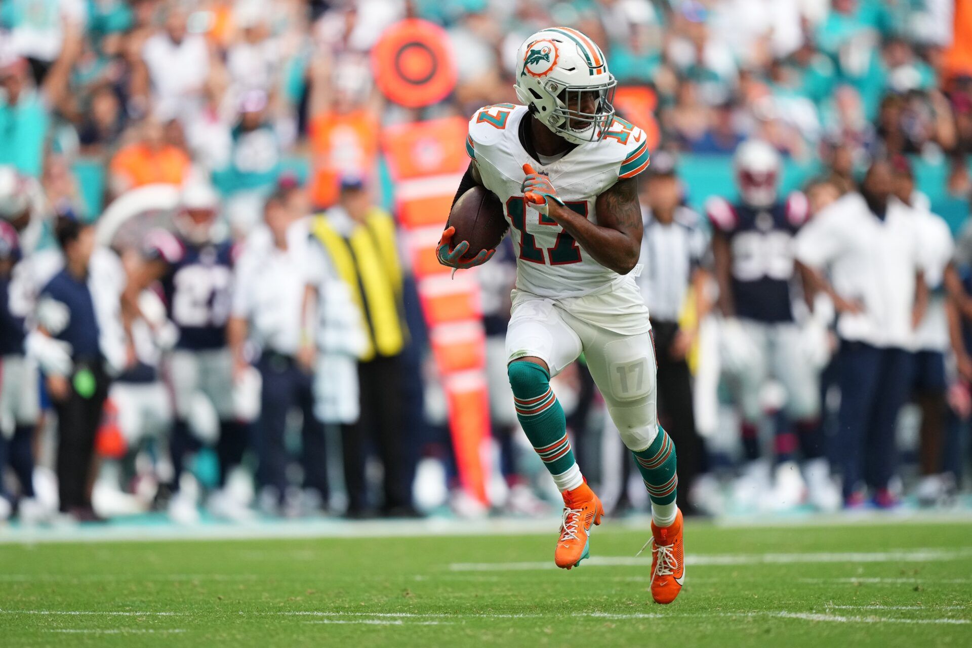 Miami Gardens, Florida, USA; Miami Dolphins wide receiver Jaylen Waddle (17) runs with the ball for a touchdown against the New England Patriots during the second half at Hard Rock Stadium.