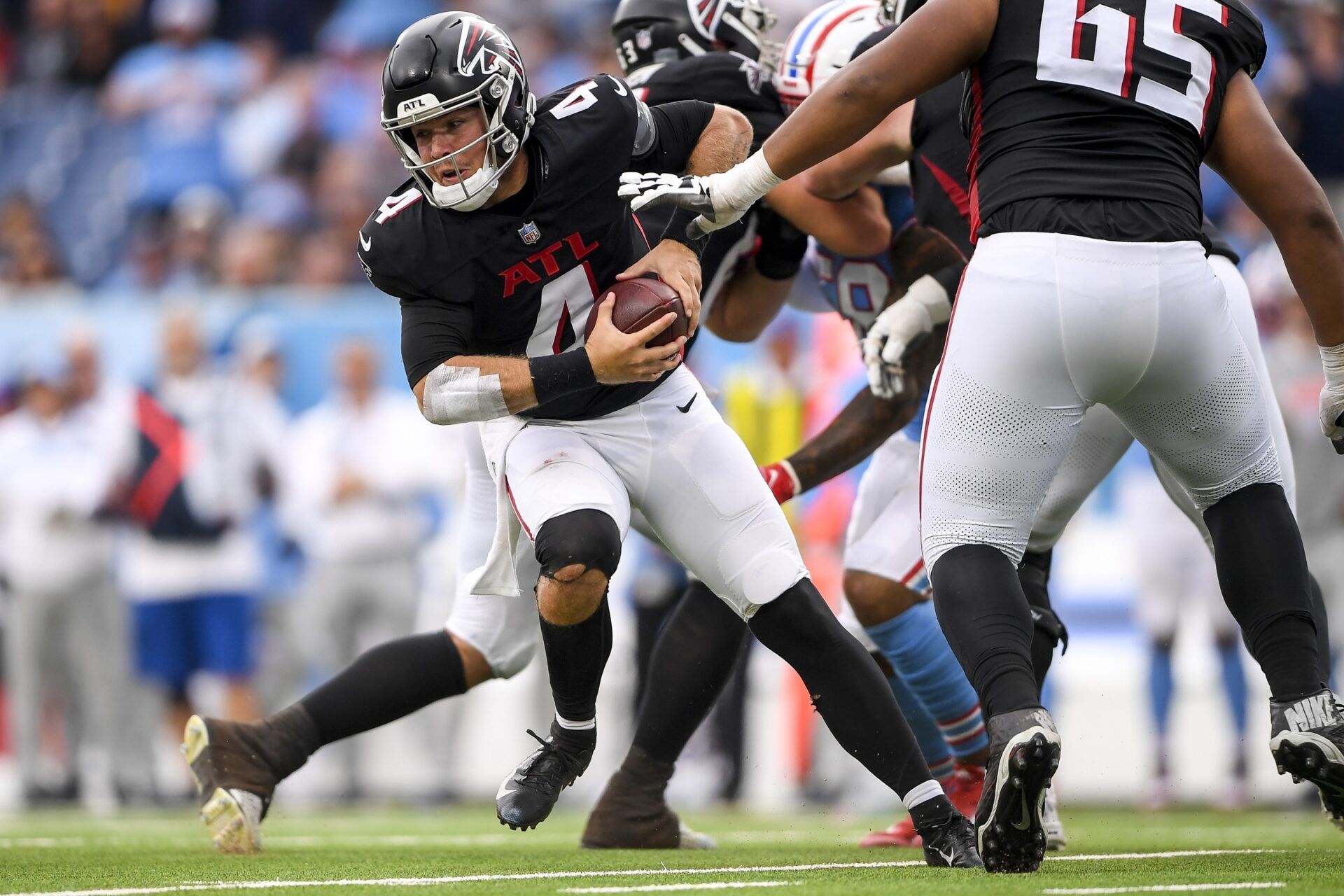 Atlanta Falcons quarterback Taylor Heinicke (4) the the ball against the Tennessee Titans during the second half at Nissan Stadium.